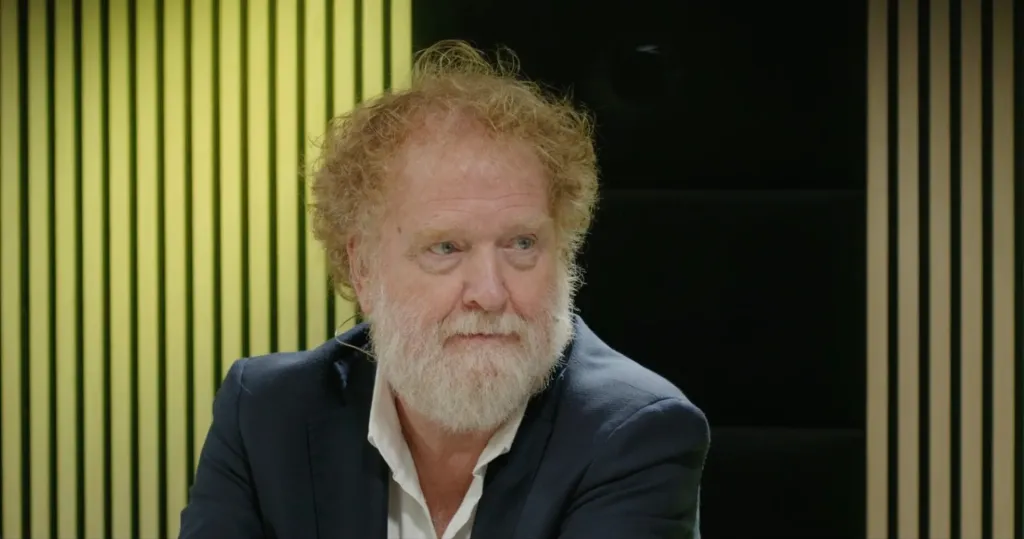 Gast luistert aan tafel tijdens het webinar